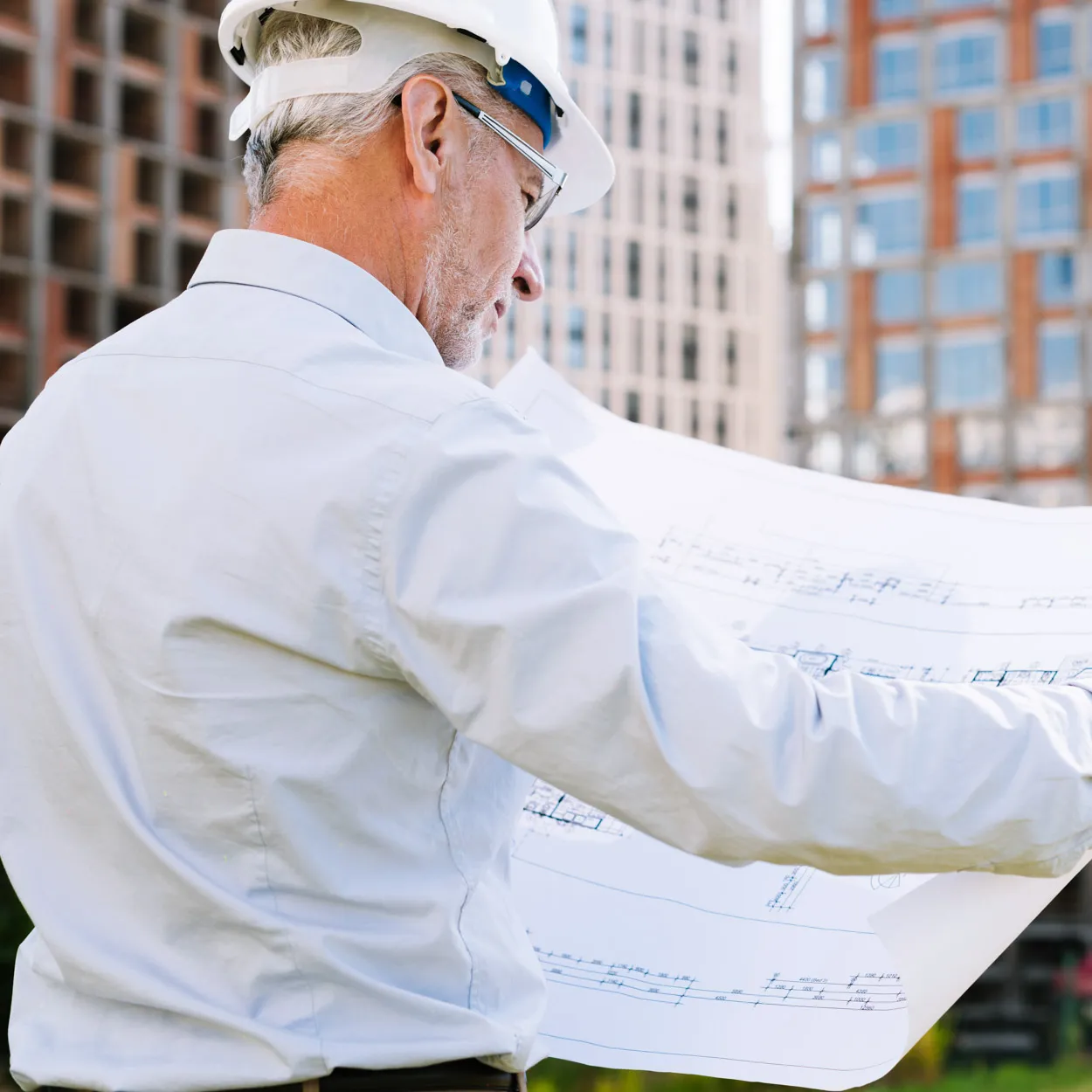 Supervisor de mantenimiento revisando planos de construcción, representando el soporte de mantenimiento ágil de GQM Inc. en Florida.